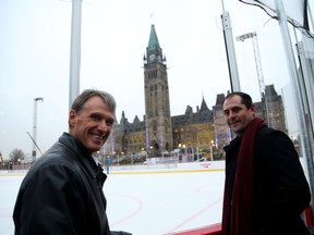 Chris Phillips (R) and Laurie Boschman (1st captain in the Ottawa Senators history) pose in front of the ice rink on Parliament Hill in Ottawa, November 30, 2017.  Photo by Jean Levac Assignment # 128076