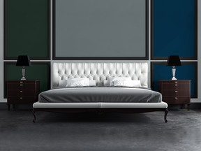 Judiciously placed panels of Sico green, grey and blue, framed in black, form a striking backdrop for the bed in this tableau.