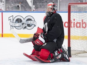 Ottawa Senators goalie Craig Anderson kneels in his crease as he watches drills during an outdoor practice Friday December 15, 2017 in Ottawa.