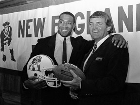 FILE - In this April 11, 1984, file photo, newly signed New England Patriots football player Irving Fryar, left, poses with Patriots coach Ron Meyer during a press conference in Foxborough, Mass. From SMU's "Pony Express" to the NFL's infamous "Snowplow Game," former college and professional football coach Ron Meyer was in the middle of some of the game's most controversial and colorful teams and moments in the 1980s. Meyer died Tuesday, Dec. 5, 2017, in Austin, Texas, at age 76.