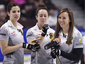 Skip Rachel Homan smiles at the end of the eighth end as lead Lisa Weagle and second Joanne Courtney look on at the Canadian Tire Centre on Saturday, Dec. 9, 2017.