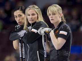 Team Jones skip Jennifer Jones, centre, stands with second Jill Officer and lead Dawn McEwen, right, during the Canadian Olympic curling trials against team Englot, in Ottawa on Sunday THE CANADIAN PRESS/Adrian Wyld