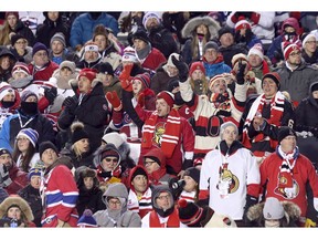 Fans cheer in the first period as the Ottawa Senators take on the Montreal Canadiens in the 2017 Scotiabank NHL 100 Classic outdoor hockey game at TD Place in Ottawa.