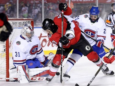 Senator Gabriel Dumont tries to put the puck past goalie Carey Price with David Schlemko (R) defending in the first period as the Ottawa Senators take on the Montreal Canadiens in the 2017 Scotiabank NHL 100 Classic outdoor hockey game at TD Place in Ottawa.