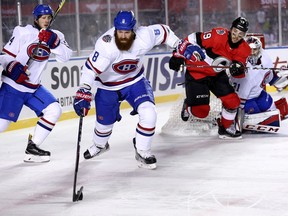 Jordie Benn skates away with the puck as Derick Brassard chases him in the third period as the Ottawa Senators take on the Montreal Canadiens in the 2017 Scotiabank NHL 100 Classic outdoor hockey game at TD Place in Ottawa.