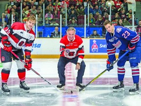 Former Ottawa 67’s great Pierre Jarry performs the ceremonial puck drop between captains Travis Barron and Jack Studnicka of the Oshawa Generals prior to last night’s OHL game at TD Place. The team honoured its top 50 players of the first 50 years before bowing 4-3 to the Generals. Photo by Valerie Wutti
