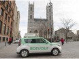 A taxi with Bonjour on the side drives past the Notre-Dame Basilica in Montreal on Thursday, November 30, 2017. The National Assembly is formally asking Quebec's merchants to "warmly" greet their clients with the word "Bonjour," and drop the old standard "Bonjour-hi."