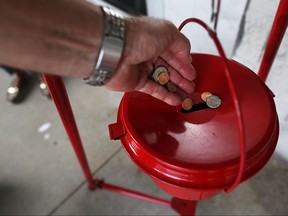 A donation is made into a Salvation Army red kettle on Giving Tuesday on November 28, 2017 in Hallandale, Florida. (Joe Raedle/Getty Images)