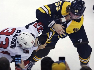 Bruins centre Tim Schaller fights Senators defenceman Fredrik Claesson after Claesson's high hit on Bruins teammate Noel Acciari in the first period.