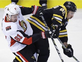 Senators winger Mark Stone checks the Bruins' Brad Marchand during the first period of Wednesday's game at Boston.