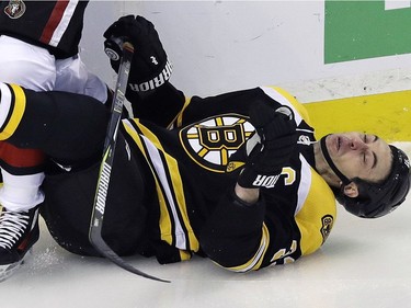 Bruins defenceman Zdeno Chara hits the ice hard after taking a check from Senators winger Bobby Ryan during the first period.