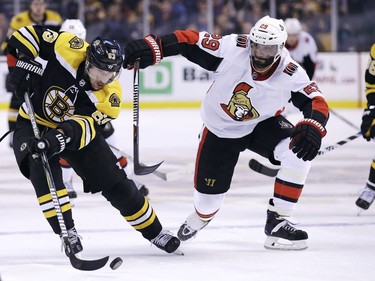 Bruins winger Brad Marchand, left, breaks towards the net as Senators defenceman Johnny Oduya tries to stay close in the second period.