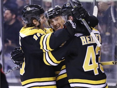 Boston Bruins center Riley Nash, second from right, is congratulated after his goal during the second period of an NHL hockey game against the Ottawa Senators in Boston, Wednesday, Dec. 27, 2017.