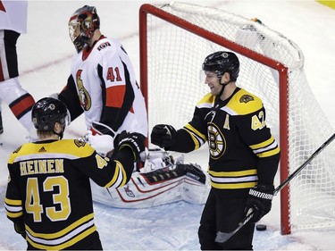 Boston right-winger David Backes (42) is congratulated by Danton Heinen after scoring against the Senators' Craig Anderson (41) during the third period.