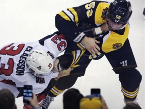 Bruins centre Tim Schaller (59) fights Senators defenceman Fredrik Claesson after the latter's hit on Noel Acciari in the first period of Wednesday's game in Boston.