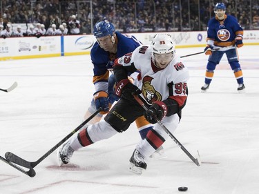 Senators centre Matt Duchene (95) controls the puck while skating against Islanders winger Jason Chimera during the third period.