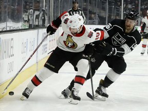 Senators winger Tom Pyatt, left, battles Kings defenceman Kurtis MacDermid for the puck during the first period of Thursday's game at Los Angeles.