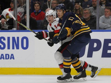 Buffalo Sabres forward Jordan Nolan (17) and Ottawa Senators forward Alexandre Burrows (14) race to the puck during the first period of an NHL hockey game, Tuesday Dec. 12, 2017, in Buffalo, N.Y.