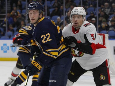 Buffalo Sabres forward Johan Larsson (22) and Ottawa Senators defenseman Cody Ceci (5) battle for position during the first period of an NHL hockey game, Tuesday Dec. 12, 2017, in Buffalo, N.Y.