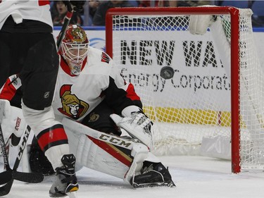 Ottawa Senators goalie Mike Condon (1) keeps his eyes on the puck during the first period of an NHL hockey game against the Buffalo Sabres, Tuesday Dec. 12, 2017, in Buffalo, N.Y.