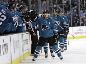 San Jose Sharks' Logan Couture, center, celebrates with teammates after scoring a goal against the Ottawa Senators during the first period of an NHL hockey game Saturday, Dec. 9, 2017, in San Jose, Calif.