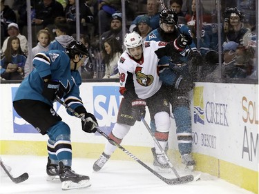 San Jose defenceman Brent Burns, right, collides with Ottawa winger Mike Hoffman during the first period of play.