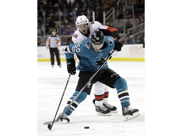 San Jose Sharks' Chris Tierney (50) is defended by Ottawa Senators' Bobby Ryan (9) during the second period of an NHL hockey game Saturday, Dec. 9, 2017, in San Jose, Calif.
