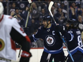 Jets players celebrate a goal against the Ottawa Senators on Sunday night in Winnipeg. (Kevin King/Postmedia Network)