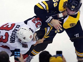 Boston Bruins centre Tim Schaller and Ottawa Senators defenceman Fredrik Claesson fight in front of fans during a game on Dec. 27, 2017