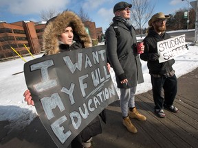 Algonquin College students (from left) Serene Deir, hairstyling student, Keenan Smith-Soro and Shane Plumb-Saumure, both journalism students, stand at the entrance to their campus on Woodroffe Ave to protest the loss of 5 weeks of school and the cramming of what remains of their semester into considerably less weeks than they had hoped.