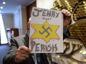 A piece of hate mail is held at a synagogue in Montreal on Tuesday Dec. 19, 2017.