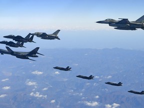 In this photo provided by South Korea Defense Ministry, U.S. Air Force B-1B bomber, far left, South Korea and U.S. fighter jets fly over the Korean Peninsula during the combined aerial exercise, South Korea, Wednesday, Dec. 6, 2017. The United States flew a B-1B supersonic bomber over South Korea on Wednesday in part of a massive combined aerial exercise involving hundreds of warplanes, a clear warning after North Korea last week tested its biggest and most powerful missile yet. (South Korea Defense Ministry via AP)