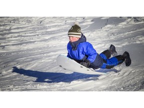 Ottawa was issued another extreme cold warning but that didn't stop people from getting out and enjoying the bright sunshine the city was blanket with Saturday Jan. 13, 2018. Six-year-old Owen Cooper was enjoying the little jump he found on the hill at Westboro Beach Saturday.   Ashley Fraser/Postmedia