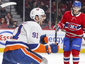 N.Y. Islanders John Tavares celebrates his game-winning goal during overtime of National Hockey League game against the Montreal Canadiens in Montreal Monday Jan. 15, 2018 as Habs Jonathan Drouin watches.