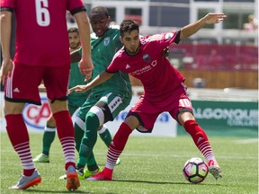 Midfielder Gerardo Bruna, right, battles the Rochester Rhinos' Bradley Kamdem Fewo for the ball during one of 26 USL matches he played for Fury FC during the 2017 season.   Ashley Fraser/Postmedia