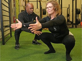 Chris Raynor and Mandy show off a sequence of exercise to stay fit on a daily basis at their Human 2.0 facility in Ottawa. Jean Levac/Postmedia