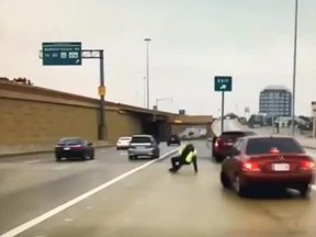 In this sceengrab, Officer Jonathan Cramer of the Hurst Police Department in Texas slips on ice as a car barrels towards him on Dec. 31, 2017.