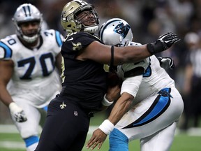 David Onyemata of the New Orleans Saints tackles Cam Newton of the Carolina Panthers at the Mercedes-Benz Superdome on Jan. 7, 2018