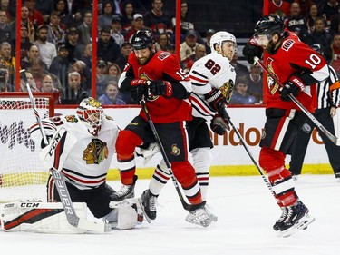 Ottawa Senators Zack Smith and Tom Pyatt screen Chicago Blackhawks goaltender Anton Forsberg as defence man Jordan Oesterle looks on during NHL action at the Canadian Tire Centre in Ottawa on January 9,2018. Errol McGihon/Postmedia