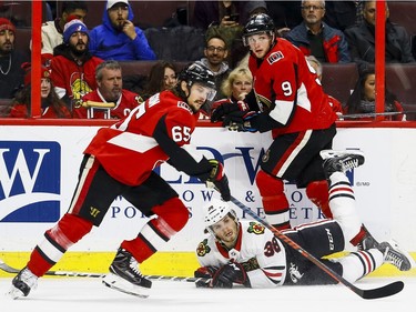 Ottawa Senators Bobby Ryan checks Chicago Blackhawks Ryan Hartman as Senators Erik Karlsson skates past during NHL action at the Canadian Tire Centre in Ottawa on January 9,2018. Errol McGihon/Postmedia