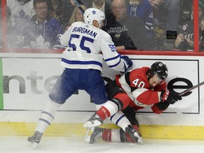 Toronto Maple Leafs defenceman Andreas Borgman checks Ottawa Senators centre Gabriel Dumont into the boards during Saturday night's game. (THE CANADIAN PRESS)