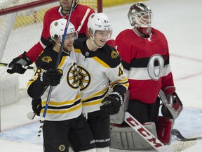 The Boston Bruins' David Pastrnak (88) congratulates Danton Heinen on his goal as Ottawa Senators goaltender Mike Condon looks on in the second period. (THE CANADIAN PRESS)