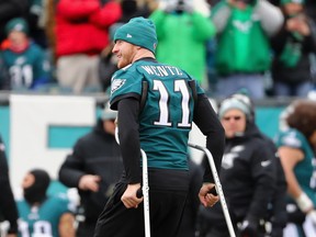 Injured quarterback Carson Wentz walks off the field before the game against the Dallas Cowboys in Decemeber. (GETTY IMAGES)