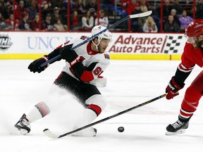 Ottawa Senators' Mike Hoffman has the puck poked away by Carolina Hurricanes' Jordan Staal during Tuesday's game. (AP PHOTO)