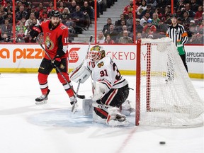 Senators forward Zack Smith watches as Anton Forsberg of the Blackhawks makes a pad save during a game at Canadian Tire Centre on Jan. 9.