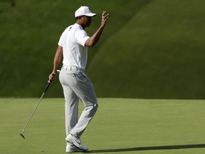 Tiger Woods reacts after making a putt on the 13th hole of the South Course at Torrey Pines Golf Course during the third round of the Farmers Insurance Open golf tournament, Saturday, Jan. 27, 2018, in San Diego.