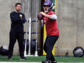 In this Jan. 11, 2018, photo, Minnesota Vikings NFL quarterback Case Keenum looks to throw a pass during football practice warmups in Eden Prairie, Minn.