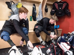 Gabe Ferron-Bouius, left, changes into his goalie gear alongside 67's rookie netminder Cédrik Andrée before practice at TD Place arena on Tuesday.  Chris Hofley, Ottawa 67's photo