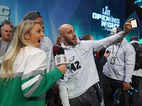 Julie Ertz of the U.S. women's soccer team and wife of Zach Ertz of the Philadelphia Eagles poses for a selfie with Jordan Hicks and Chris Maragos of the Eagles during Super Bowl Media Day at Xcel Energy Center on January 29, 2018 in St Paul, Minnesota. (Elsa/Getty Images)