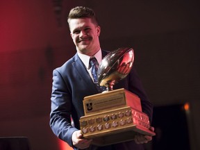 Ed Ilnicki of the University of Alberta accepts the Hec Crighton Trophy for outstanding player during the U Sports All-Canadian Football Awards Gala in Hamilton, Ont., Thursday, November 23, 2017.